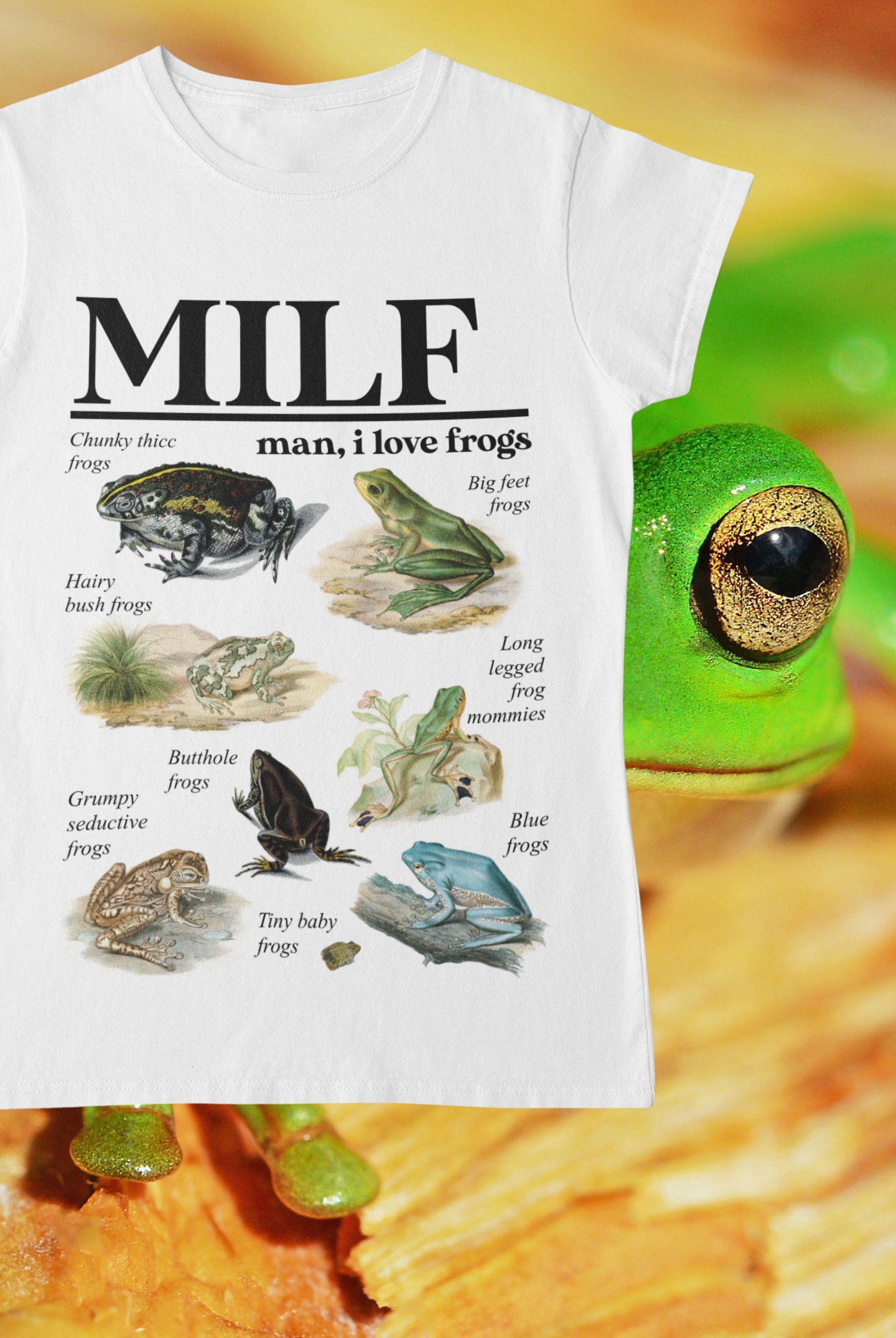 White tshirt which reads ‘MILF Man, I Love Frogs’ in a bold font at the top. Below are 8 vintage frog illustrations with whimsical titles beneath them, e.g. chunky thicc frogs and butthole frogs.